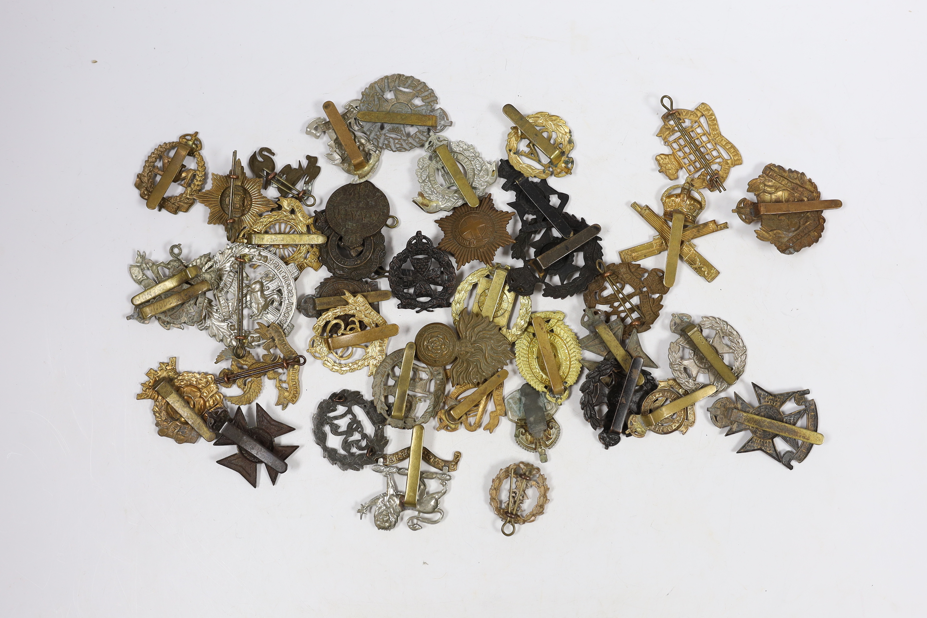 Forty military cap badges including City of London Cyclists, Lincolnshire Yeomanry, Connaught Rangers, The County of London, Royal Gloucestershire Hussars, NAAFI, Military Police, the Rangers, Sussex Yeomanry, Lanarkshir